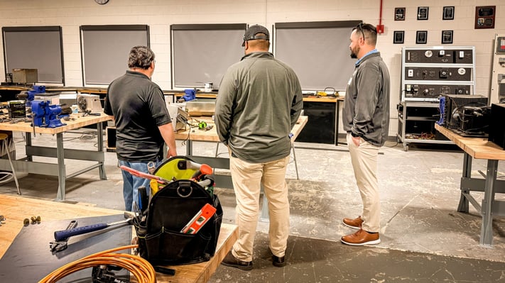 Tate Engineering team visiting a skilled trades classroom to discuss HVAC, welding and boiler career paths with students.